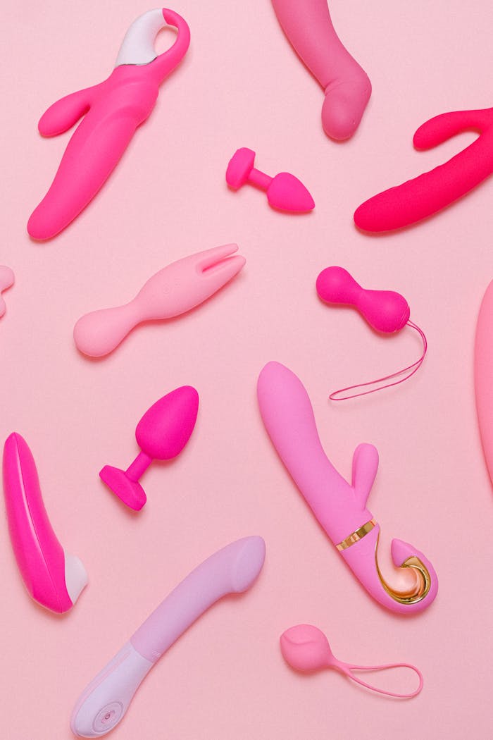 about-us Explore a variety of pink adult toys including vibrators, silicone accessories, and more on a pastel background.